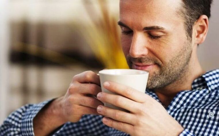 A man drinks a drink of fireweed tea to increase potency. 